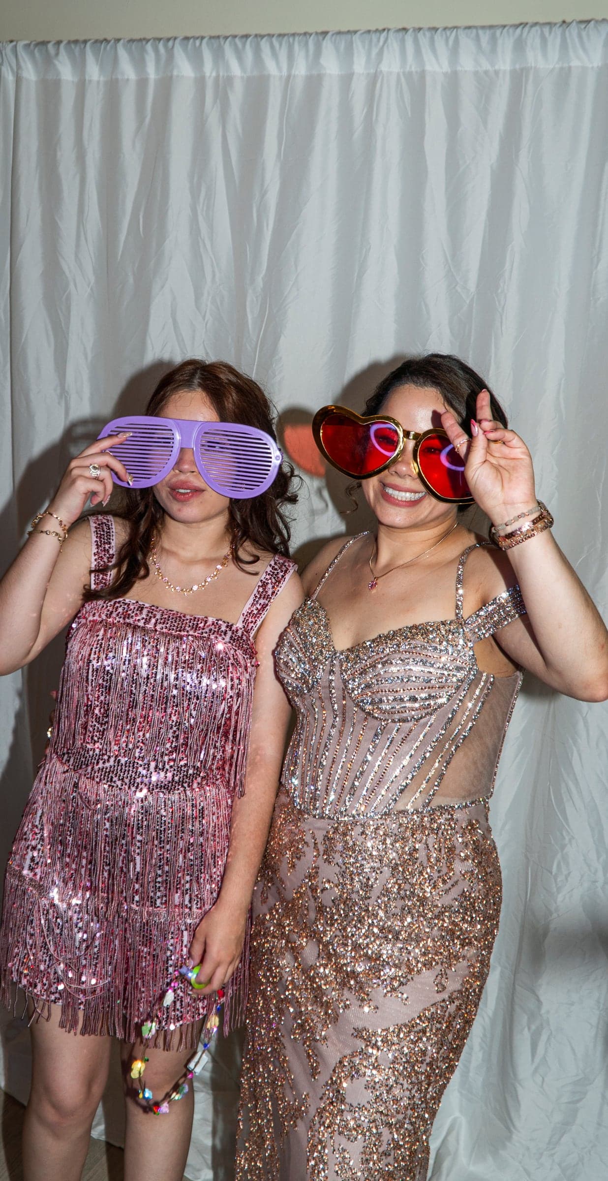 Guests posing with oversized glasses at the booth