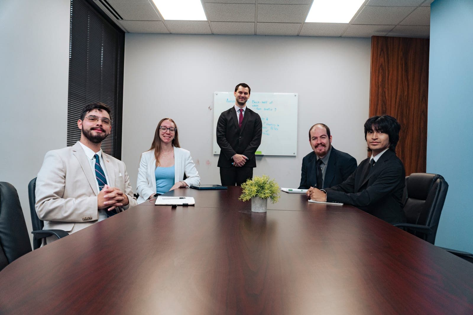 A leadership team meeting around a boardroom table