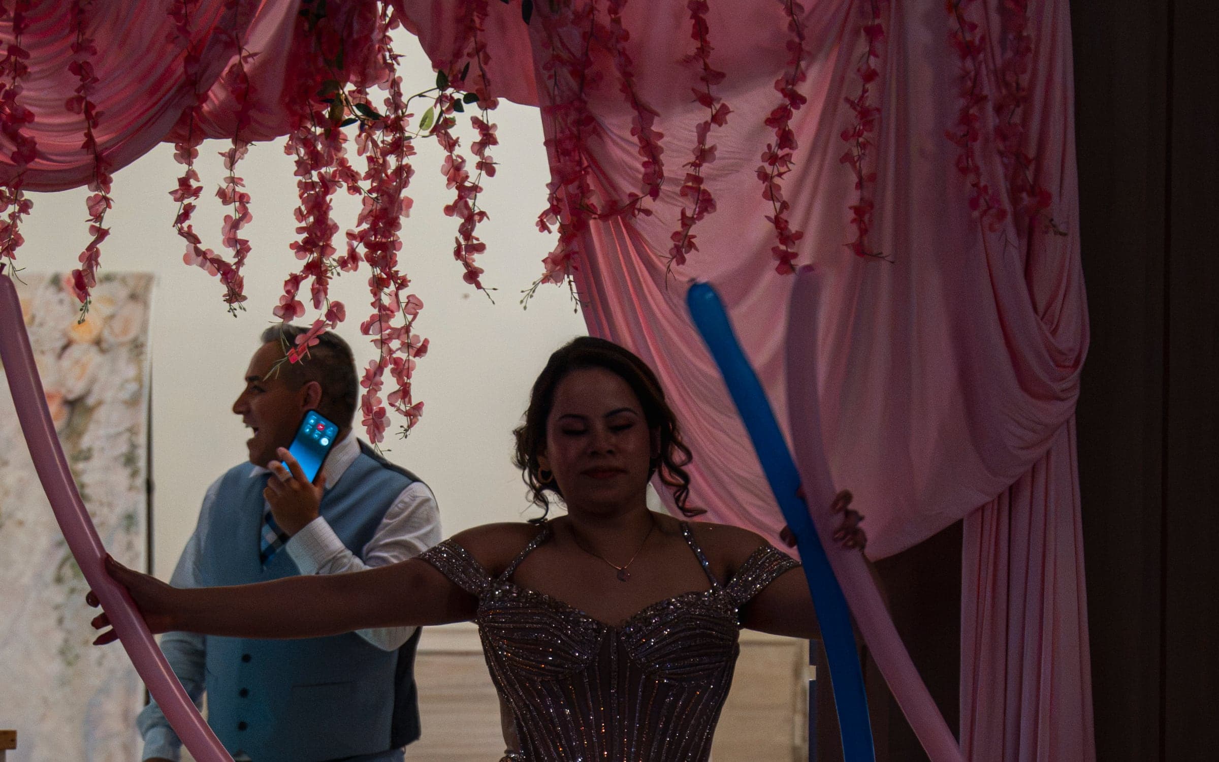 A guest making her entrance through an arch of balloons