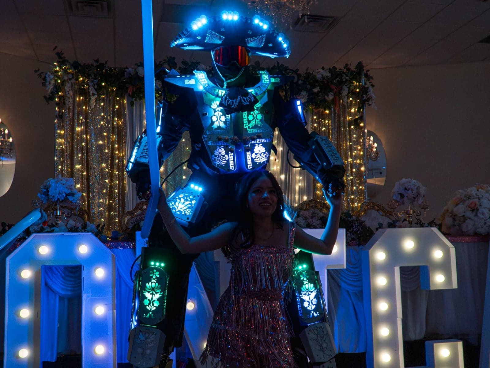 The guest of honour dancing with an LED performer beside her illuminated name